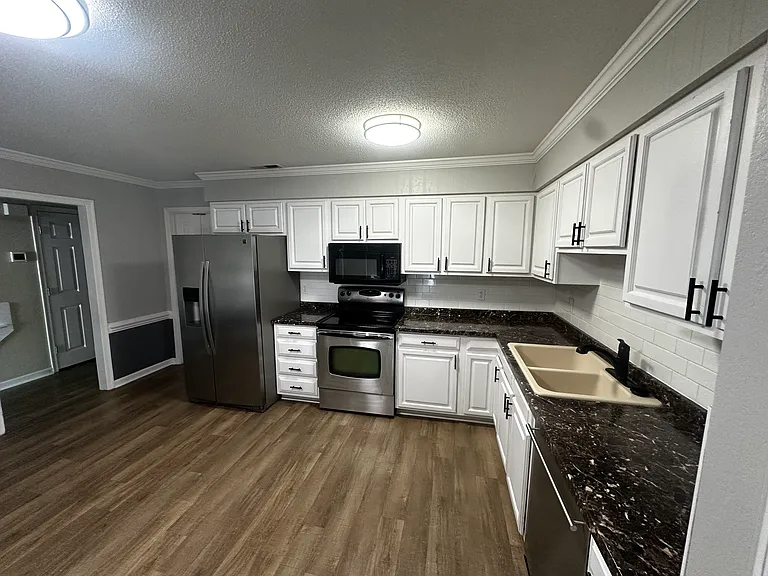 Spacious kitchen featuring a pantry and ample room for a large dining table.