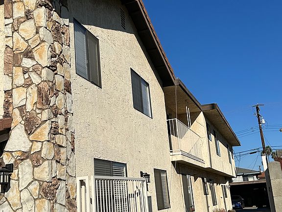 Side view with driveway leading to carport area