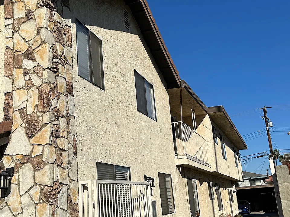 Side view with driveway leading to carport area