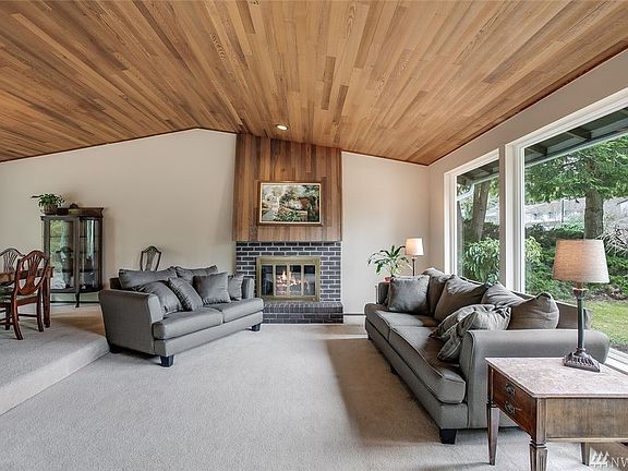 This space is made for gatherings! It is light and bright with a wall of windows and vaulted ceilings. Get cozy by the gas fireplace and enjoy connecting with guests in the open floor plan connecting the spacious living room to the large dining room.