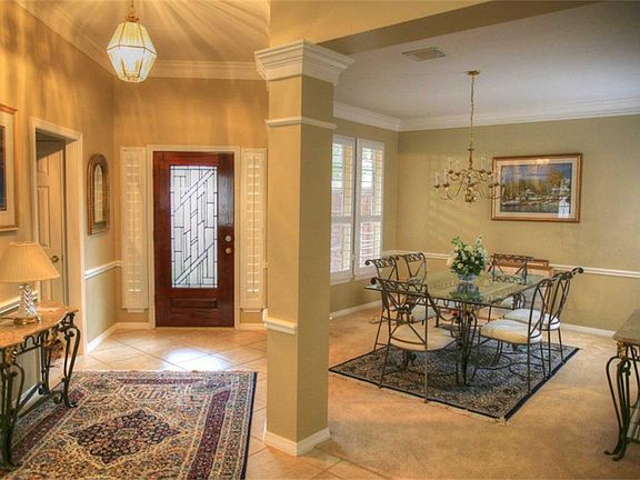 Long ceramic tile entry adjacent to formal dining area