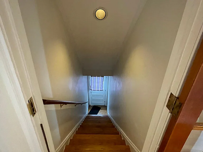 Stairway on the side of the house accessed via the rear yard.