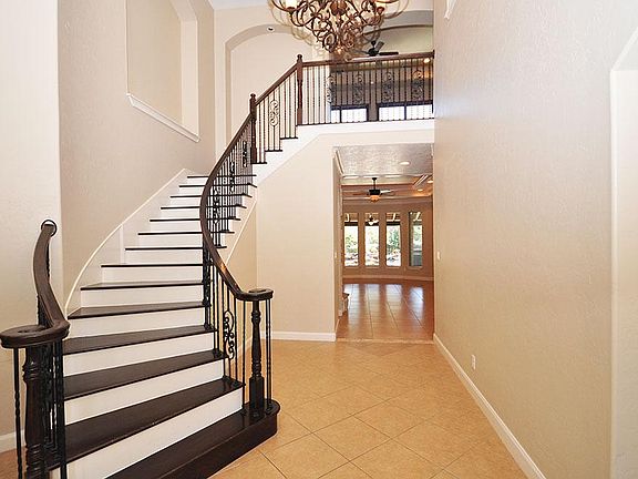 Elegant entrance to a stunning staircase with  illuminating art niches.