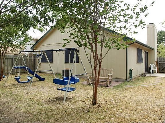 Landscaped backyard with 2 patio areas.