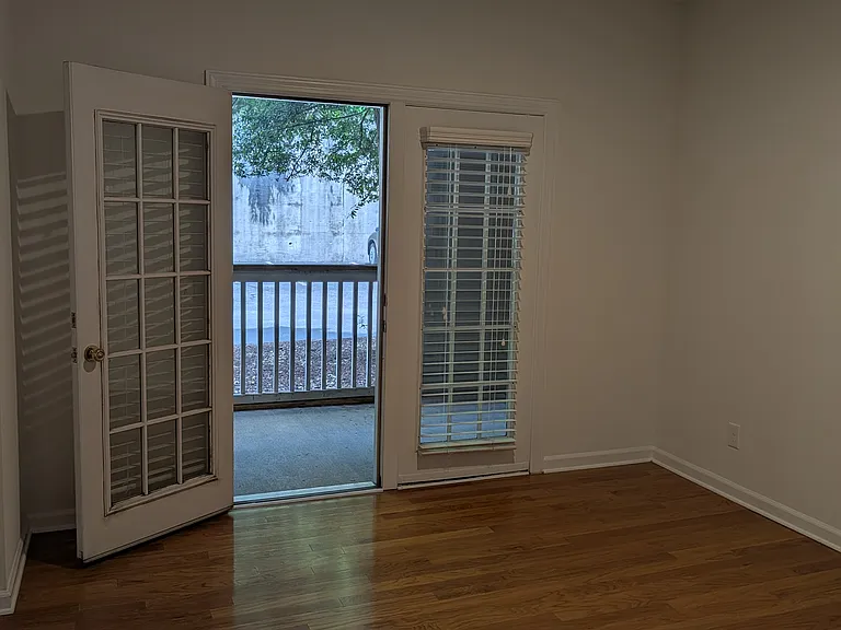 The bedroom has hardwood floors and A SECOND SCREENED IN PORCH.
