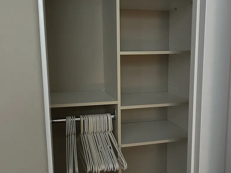 Top level 2nd bedroom closet door with hangers