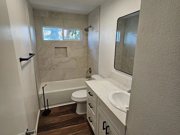 Hall bath upstairs.- new tub/ tile, cabinets, counter top, floor, toilet.