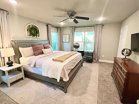 Master Bedroom with TV, desk, and King sized bed
