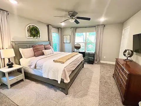 Master Bedroom with TV, desk, and King sized bed