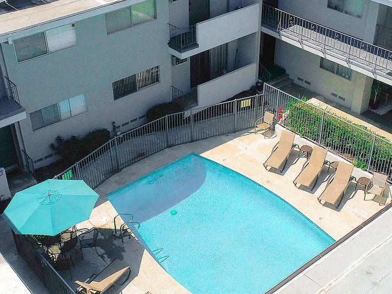 Aerial image of gated pool with lounging area.