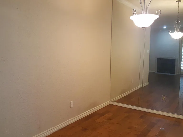 Dining area with complete wall mirror