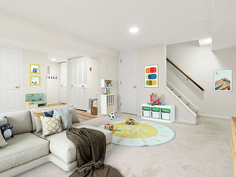 Lower Level, Family Room (with full laundry area and full bathroom) - this image is staged.