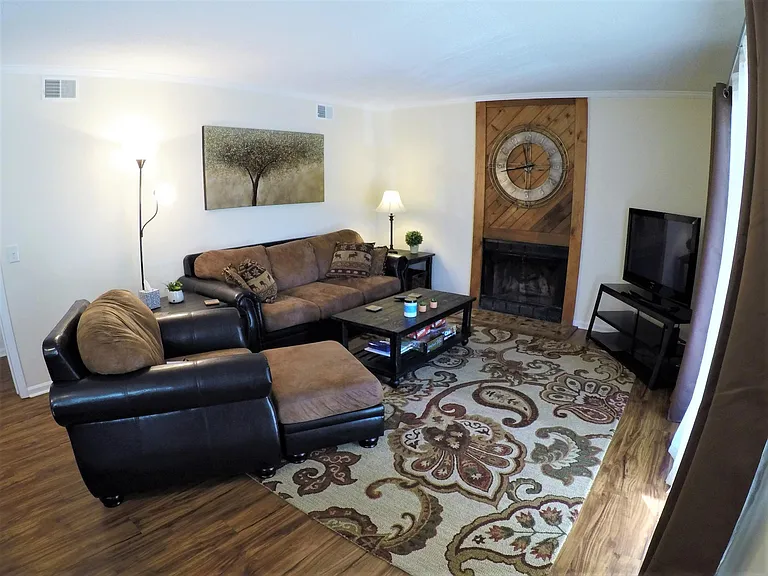 Family room with large cozy seating and a wood burning fireplace