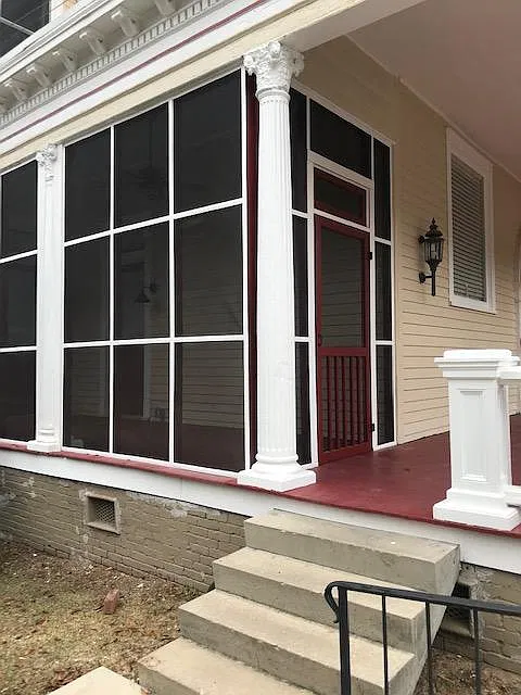view of screen porch from parking area. Plenty of on site parking steps away from this screened porch entry.