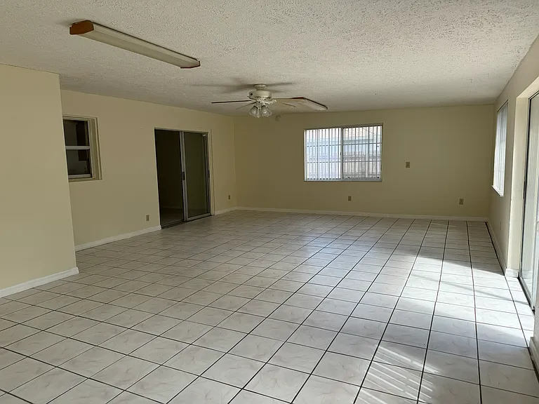 Spacious sunroom with separate sliding patio doors, off of the main dining room