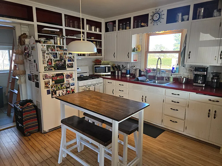 Behind the kitchen is the laundry room and stairs to the loft