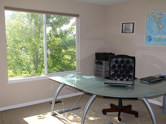 Home office or bedroom with large window and adjacent bathro