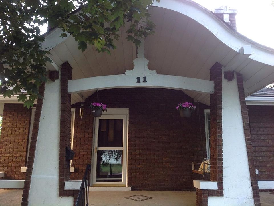 Craftsman's Style Covered Front Porch entrance with porch swing and room for plants and porch furniture