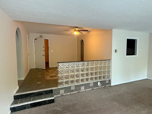 Looking from living room to the entry way and dining area