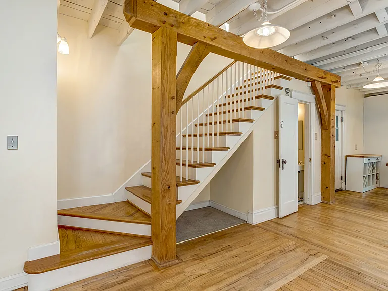 Stairs up to the second floor with a nook underneath