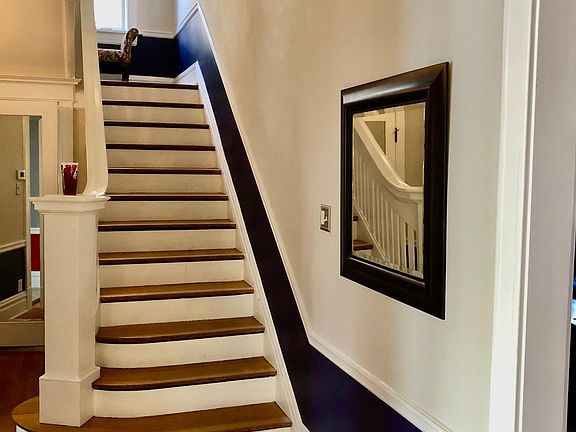Foyer and grand staircase upon entering side entry Front door