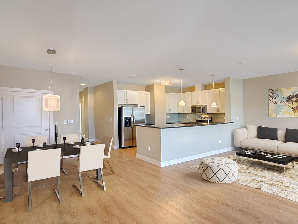 Spacious living rooms feature wood flooring throughout and open to kitchen