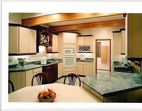 Custom kitchen with granite countertops, eat-in sunroom, and greenhouse window