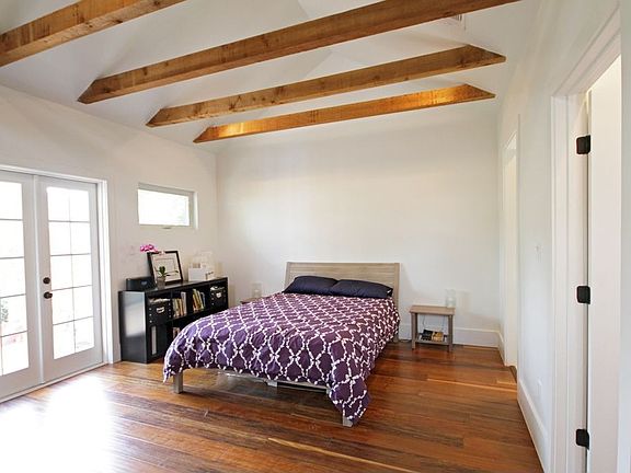 Vaulted master suite ceiling with exposed 4×6” rough cut cedar beams.
