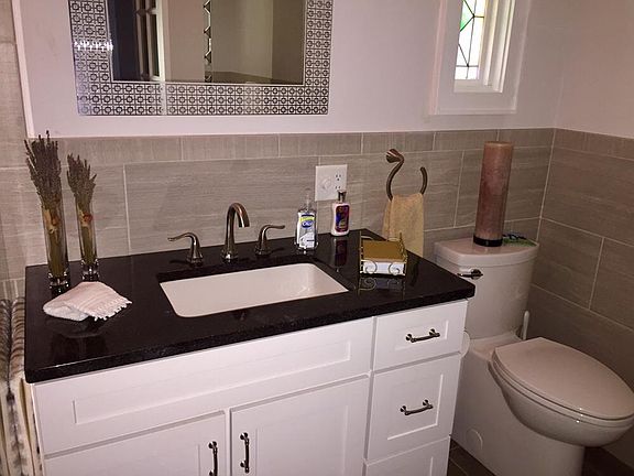 Spacious bathroom with stain glass window