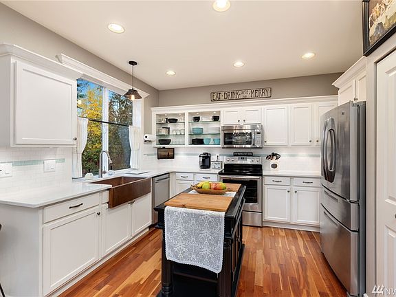 Lots of custom touches throughout the home - glass shelves with in-cabinet lights, under cabinet lighting, custom island, it's a long list.