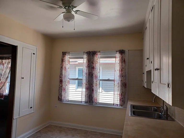 Kitchen view 2 - large enough to have a small table and chairs by windows.