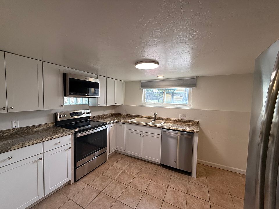 Private kitchen with stainless steel appliances inlcuding a Microwave, Electric Range, and Dishwasher.