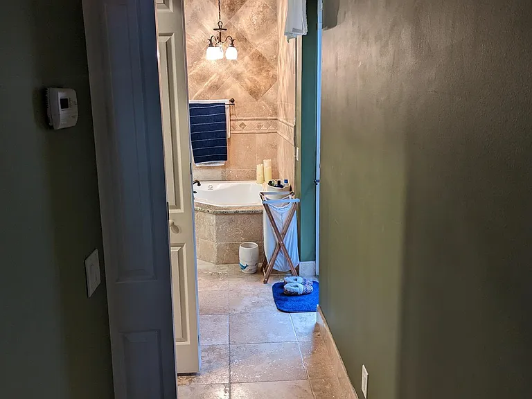 Master Suite. Opposite the game room entrance, this corridor connects the master bedroom to the master bathroom. A walk-through closet resides between the master bath and the master bedroom.