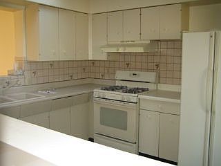 Kitchen with newer gas stove and refrigerator