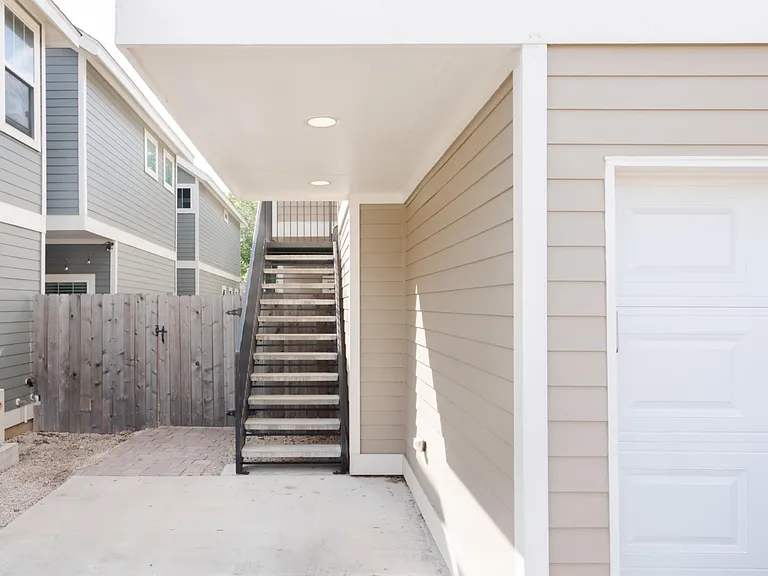 Stairway entrance to studio + 1-car garage and off street parking spot