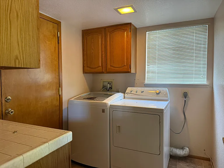 Laundry room with washer and dryer included. Leads to garage.