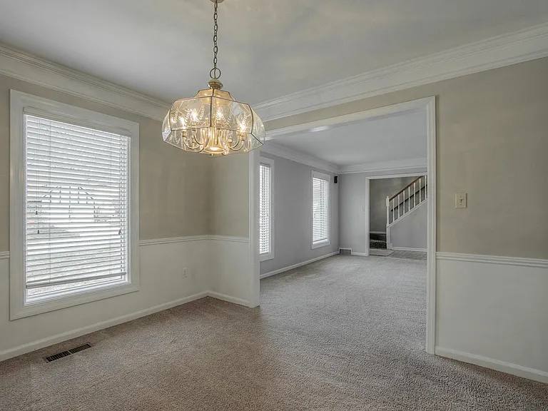 Dining flows out from kitchen and directly into the living room and front entry for easy entertaining. NEW CARPETS IN GRAY COMING SOON.