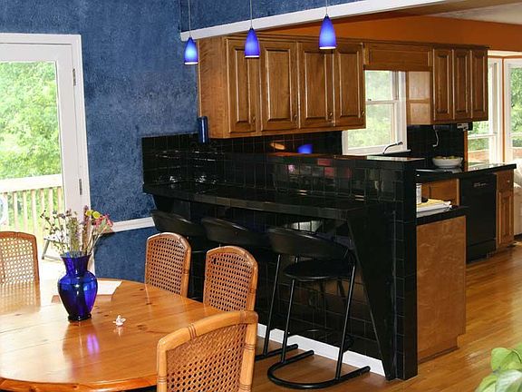 dining area open to kitchen with breakfast bar