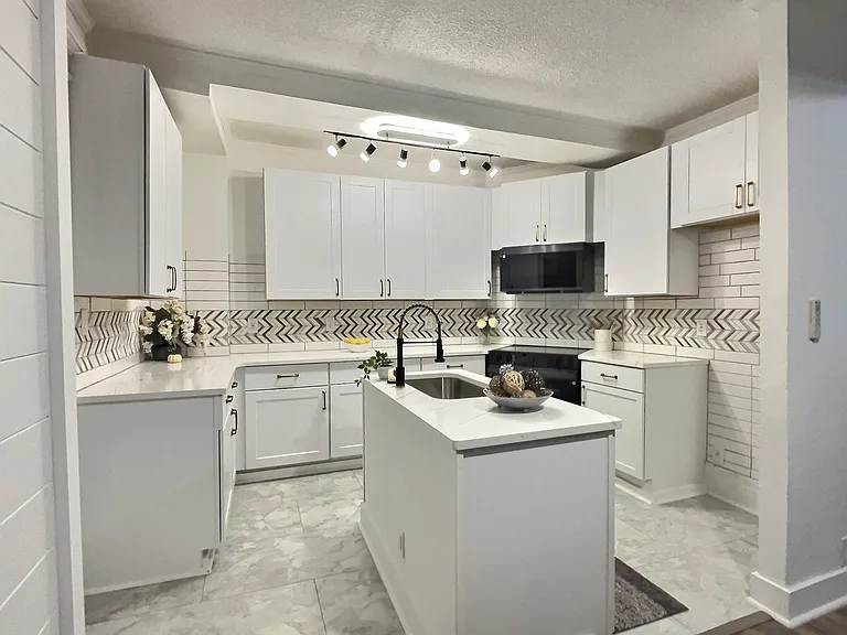 gorgeous clean brand new modern kitchen with smart glass range and over the range microwave