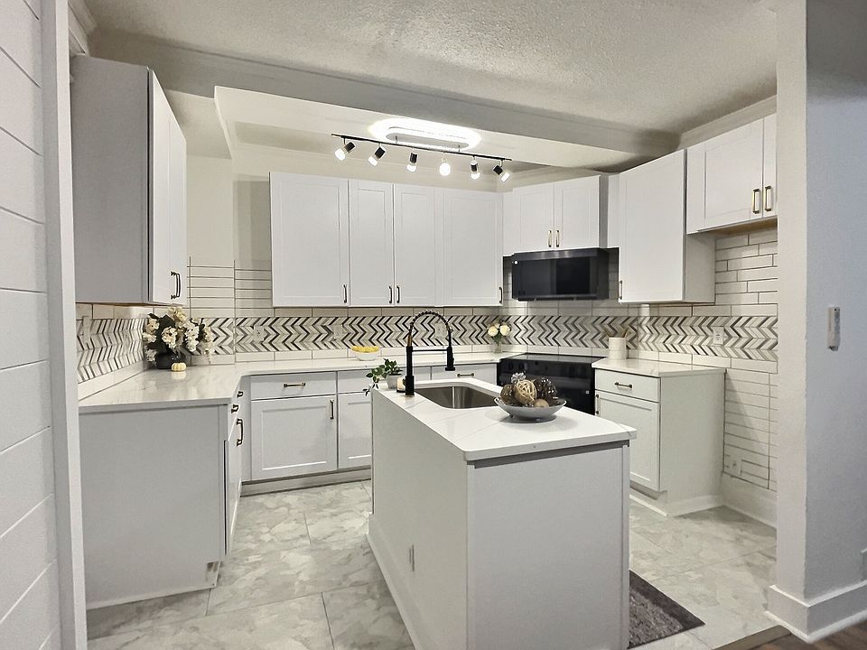 gorgeous clean brand new modern kitchen with smart glass range and over the range microwave
