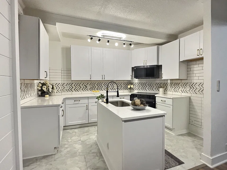 gorgeous clean brand new modern kitchen with smart glass range and over the range microwave