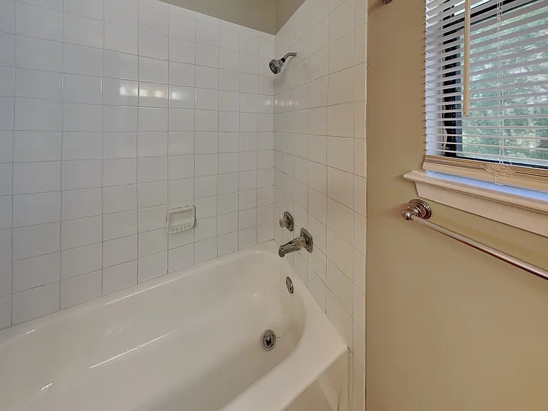 Brightly lit bathroom with whi