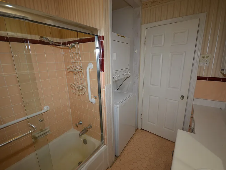 Bathroom features stackable washer & dryer.