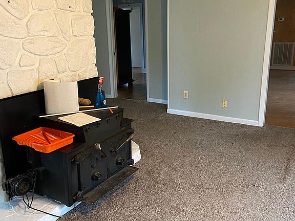 Front 2 rooms are open w/ a wood stove fireplace dividing the open space.