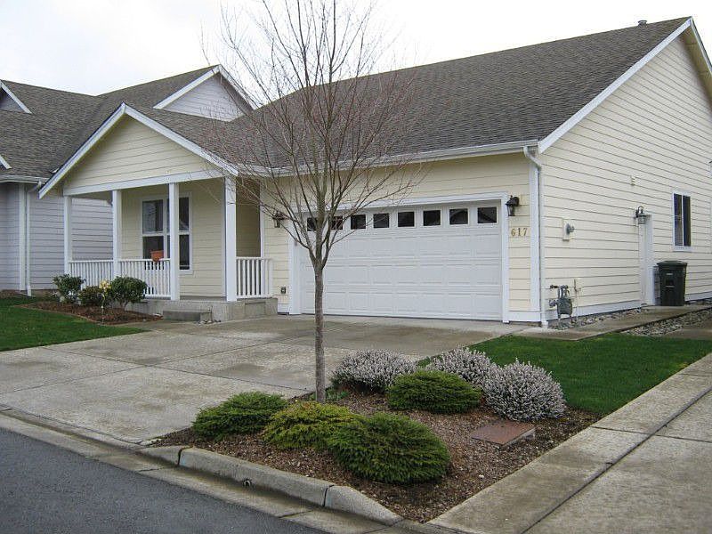 Front of the home showing level lot and driveway.