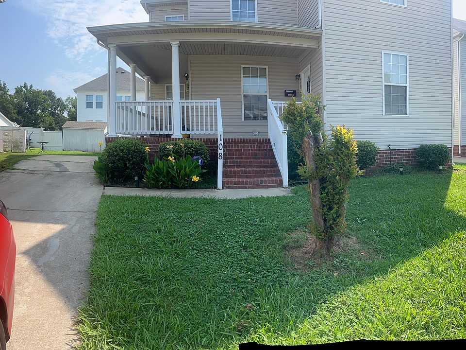 front yard with wrap around porch and driveway