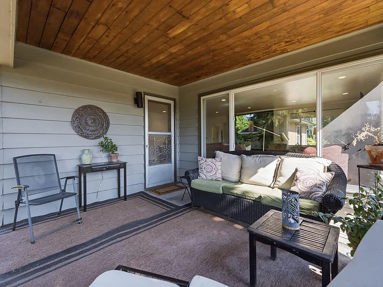 Sheltered outdoor seating on covered porch