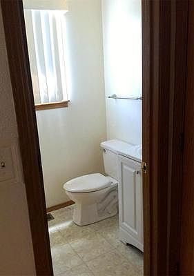 Half Bathroom just off the Kitchen with new toilet, sink, and updated counter.