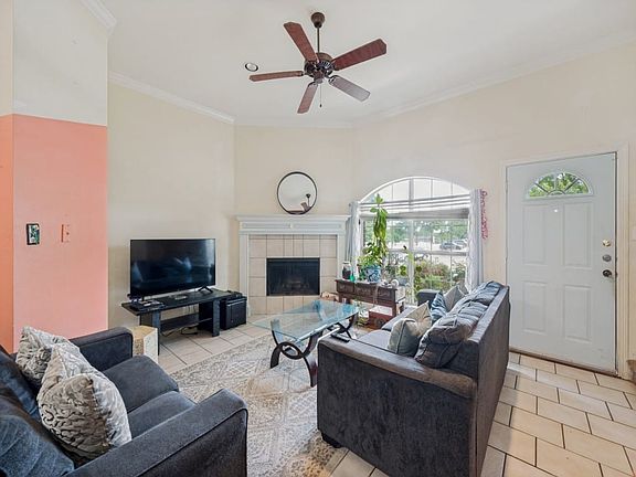 Living room features wood-burning fireplace with windows facing north, for consistent diffused dayligh. Ceramic tile unifies downstairs living and eat-in kitchen