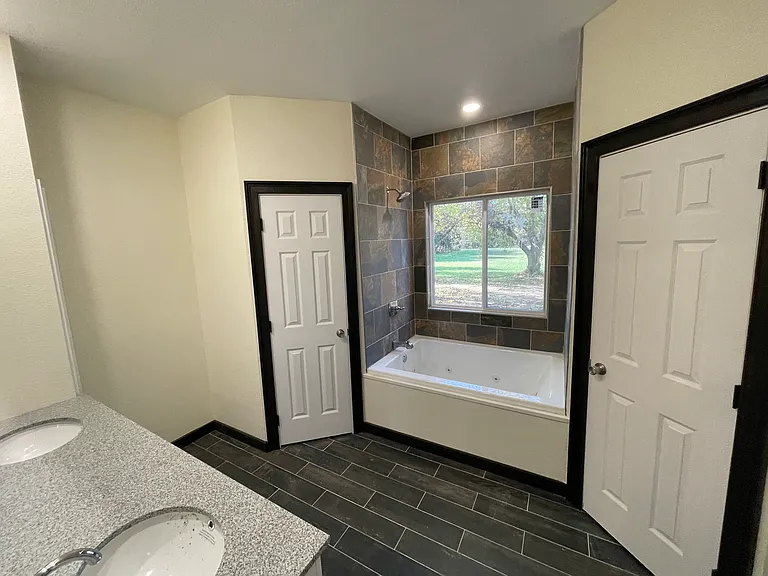 Master bath with whirlpool tub, double lavatory's and his and hers walk-in closet, tile floors